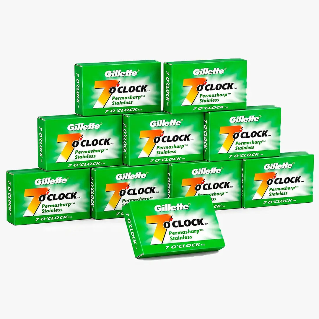 A group of Gillette 7 o'clock Permanent Sharp Stainless steel razors shown in their green retail boxes against a light gray background.