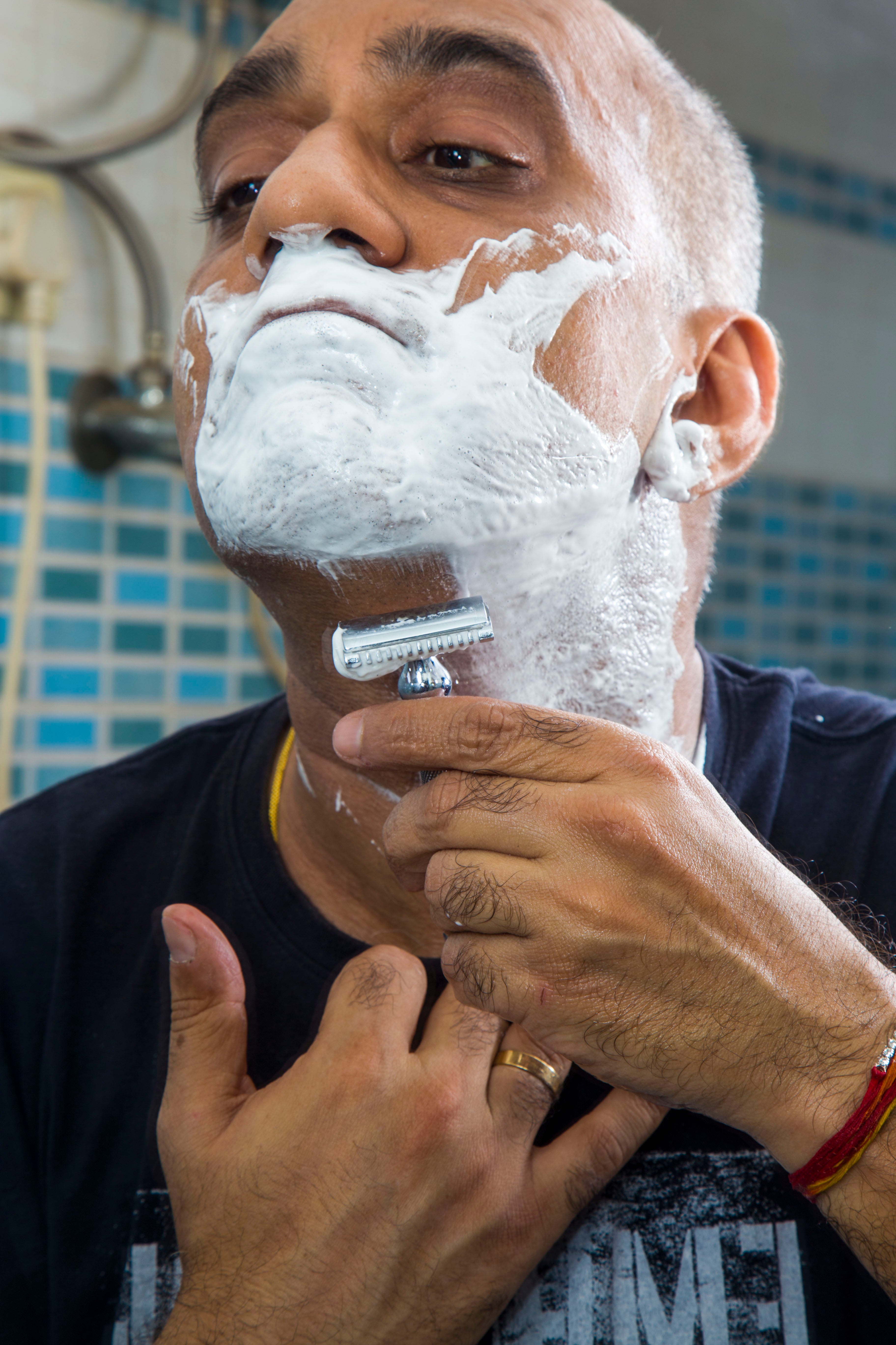 Founder of Pink Woolf shaving with a double edge safety razor using traditional wet shaving techniques.